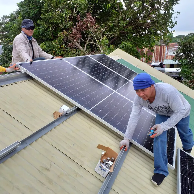 STS crew mounting PV modules on a metal roof